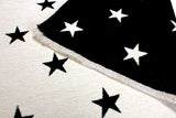 White, black, star patterned, machine washable rug for kids